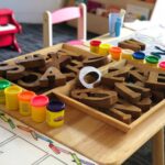 Picture of wooden block letters in a classroom with play dough surrounding
