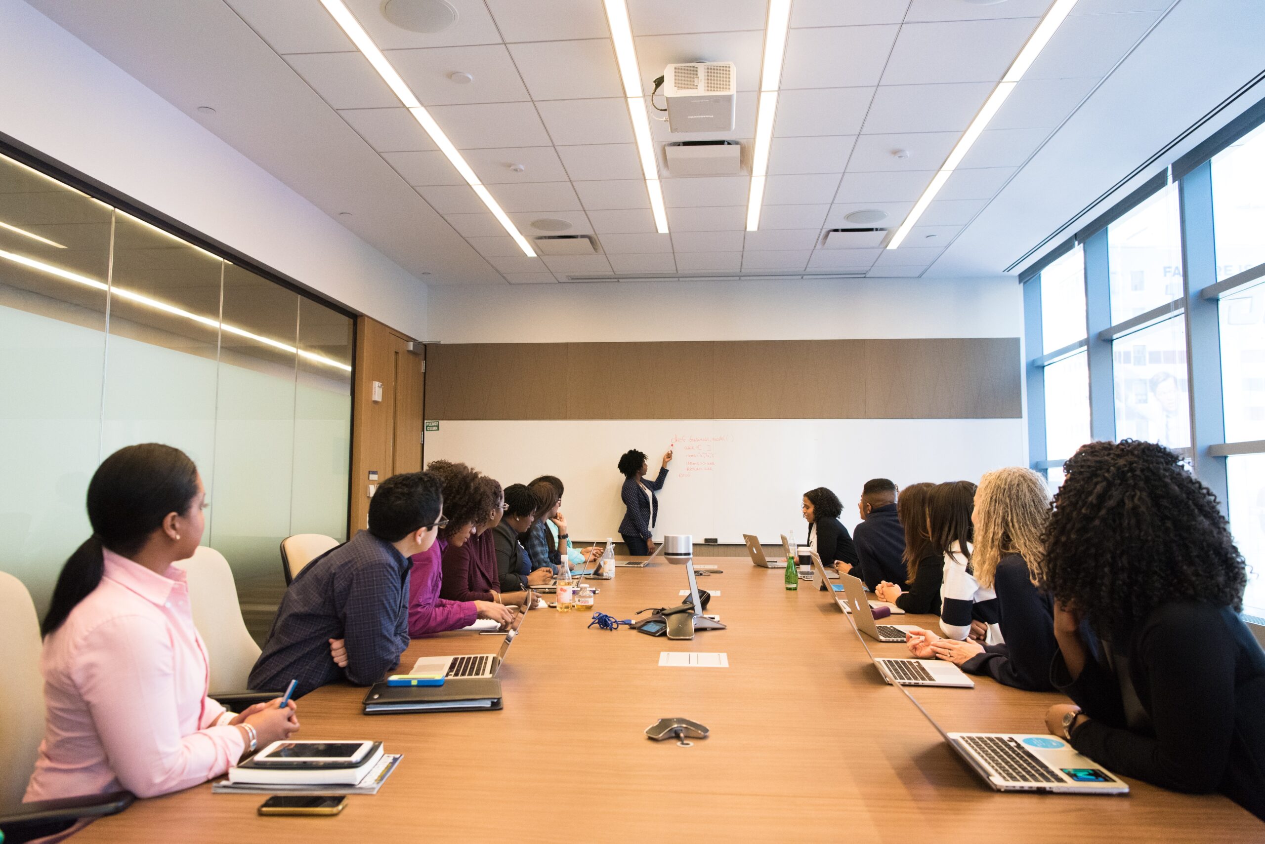 A group of people in a boardroom meeting.