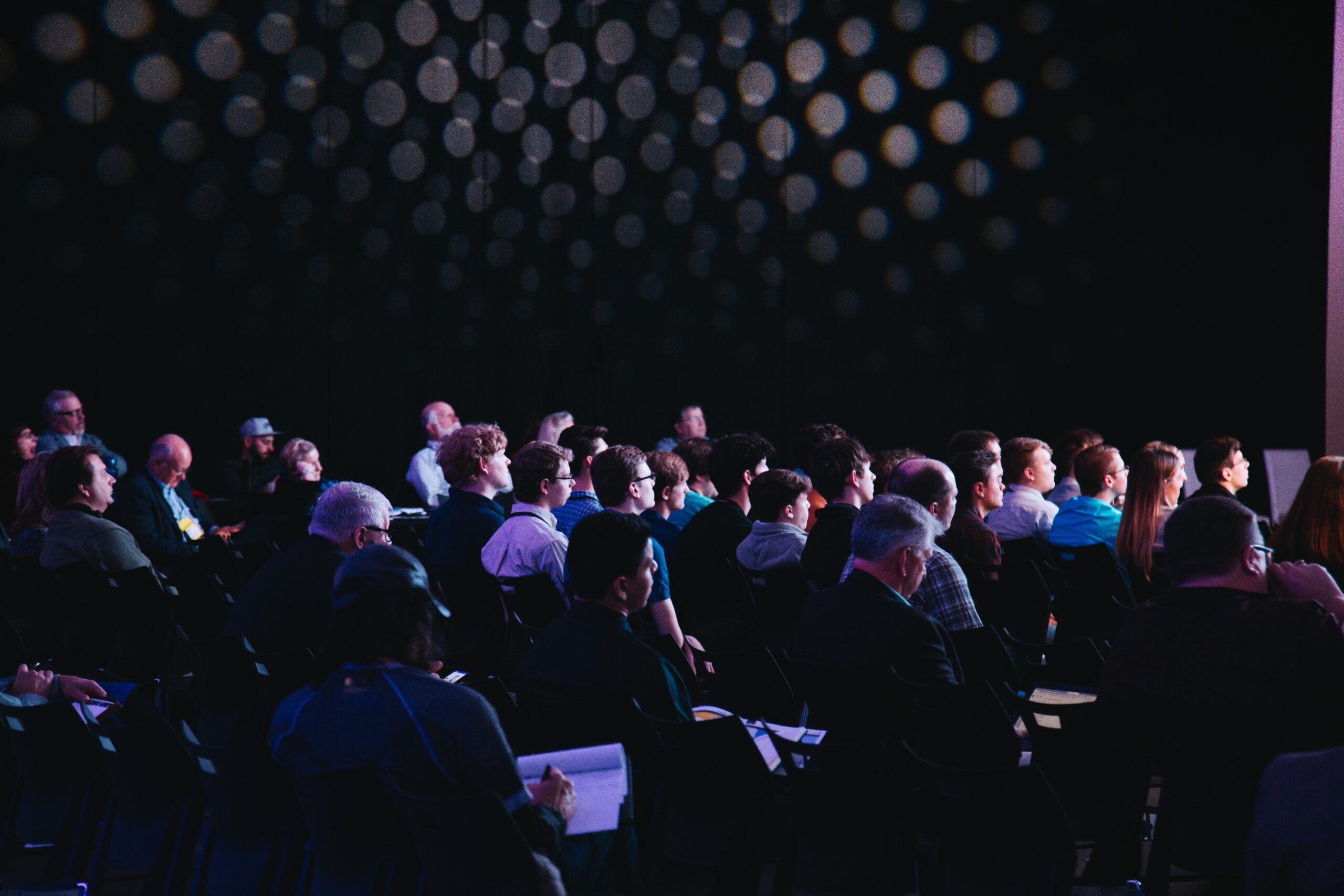 A seated audience looking to the right