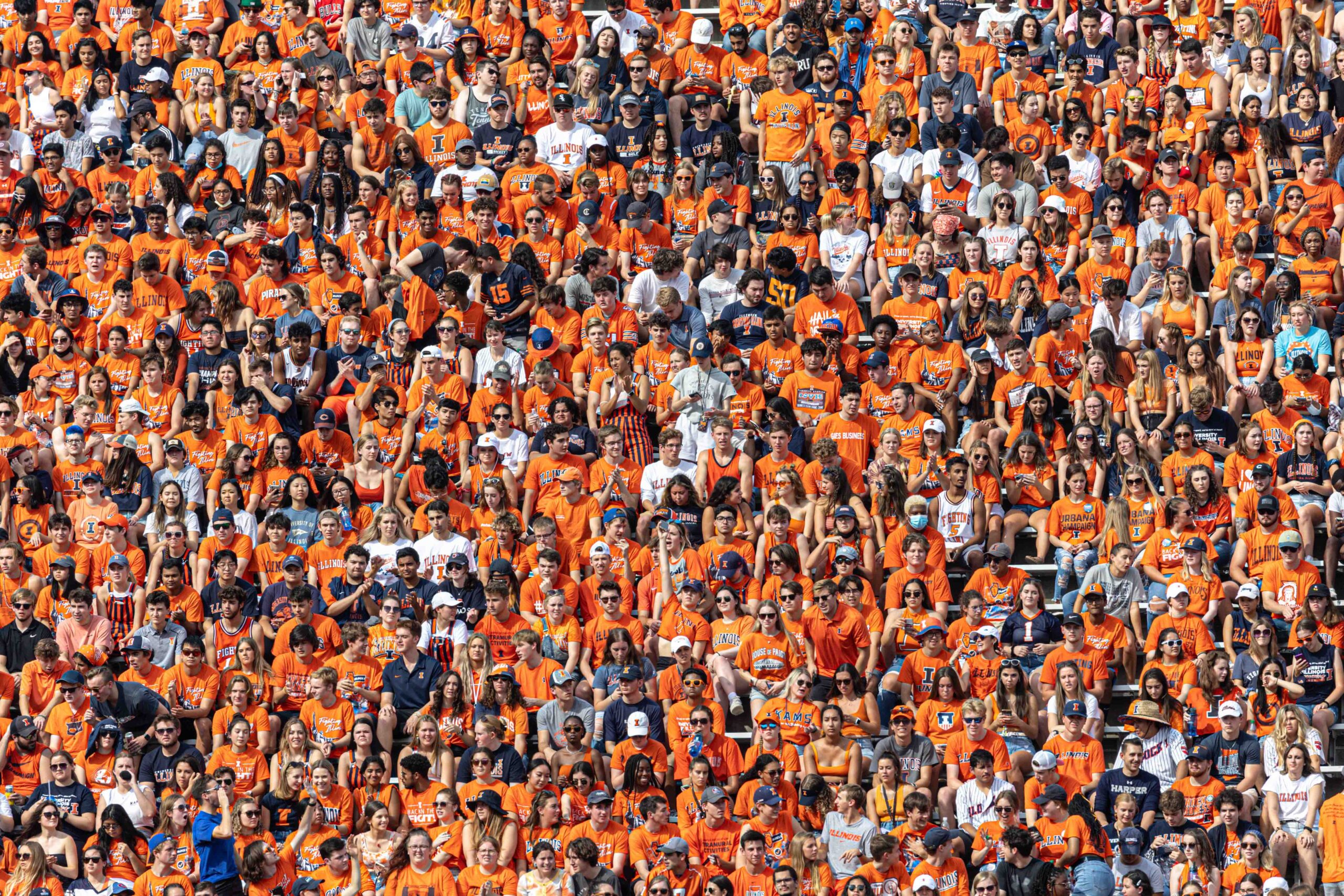 A community of people, all dressed in orange shirts.