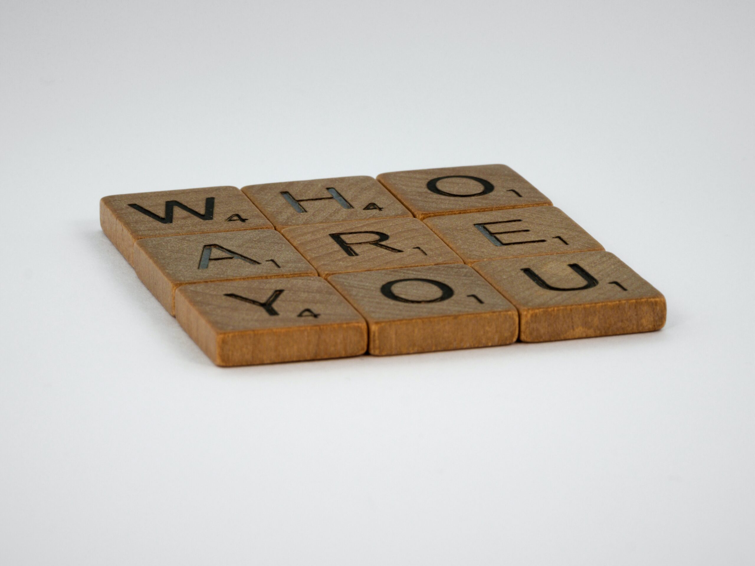 brown wooden letters saying "who are you"