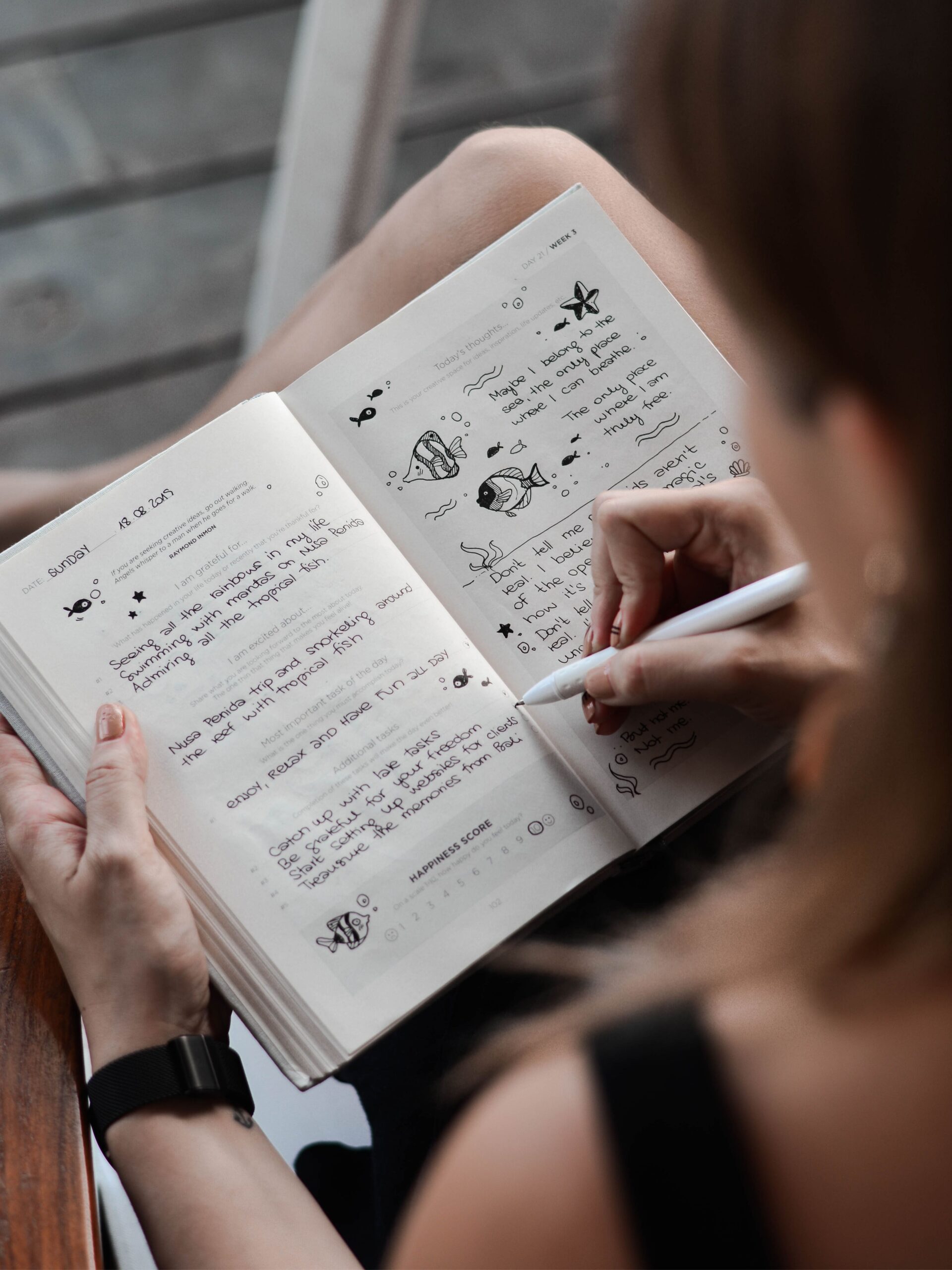 A woman is writing away in her journal.