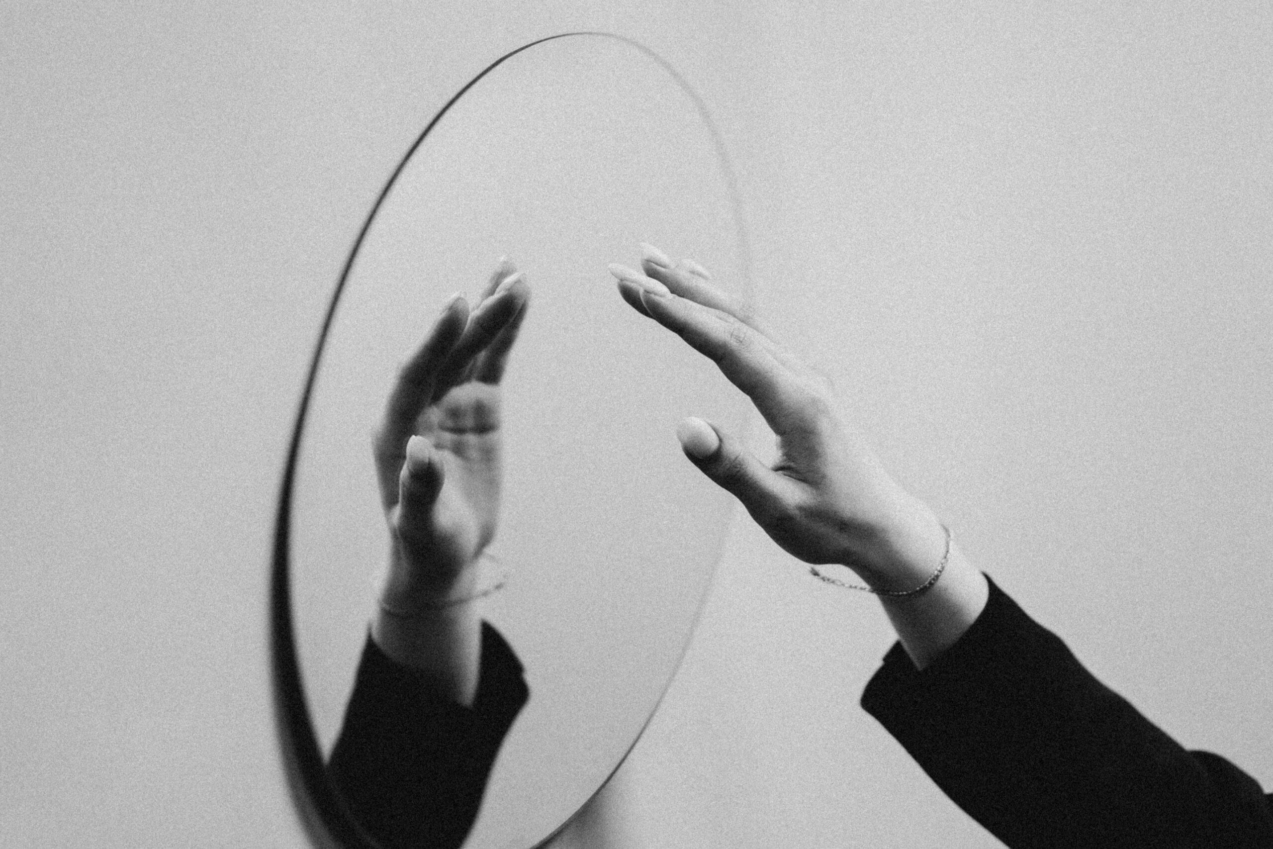 A mirror showing a reflected hand.