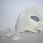 Half of a white mask on a white background