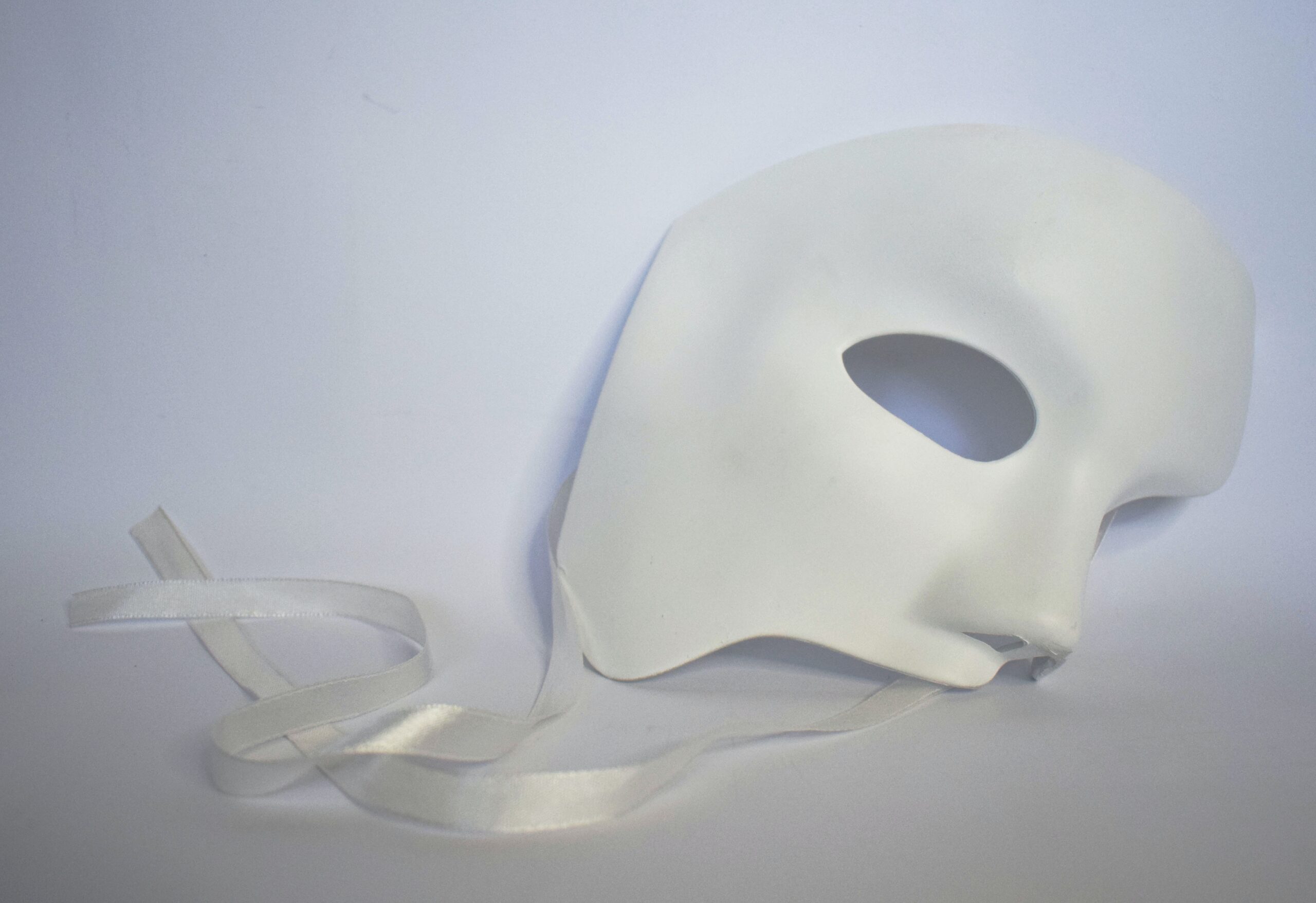 Half of a white mask on a white background