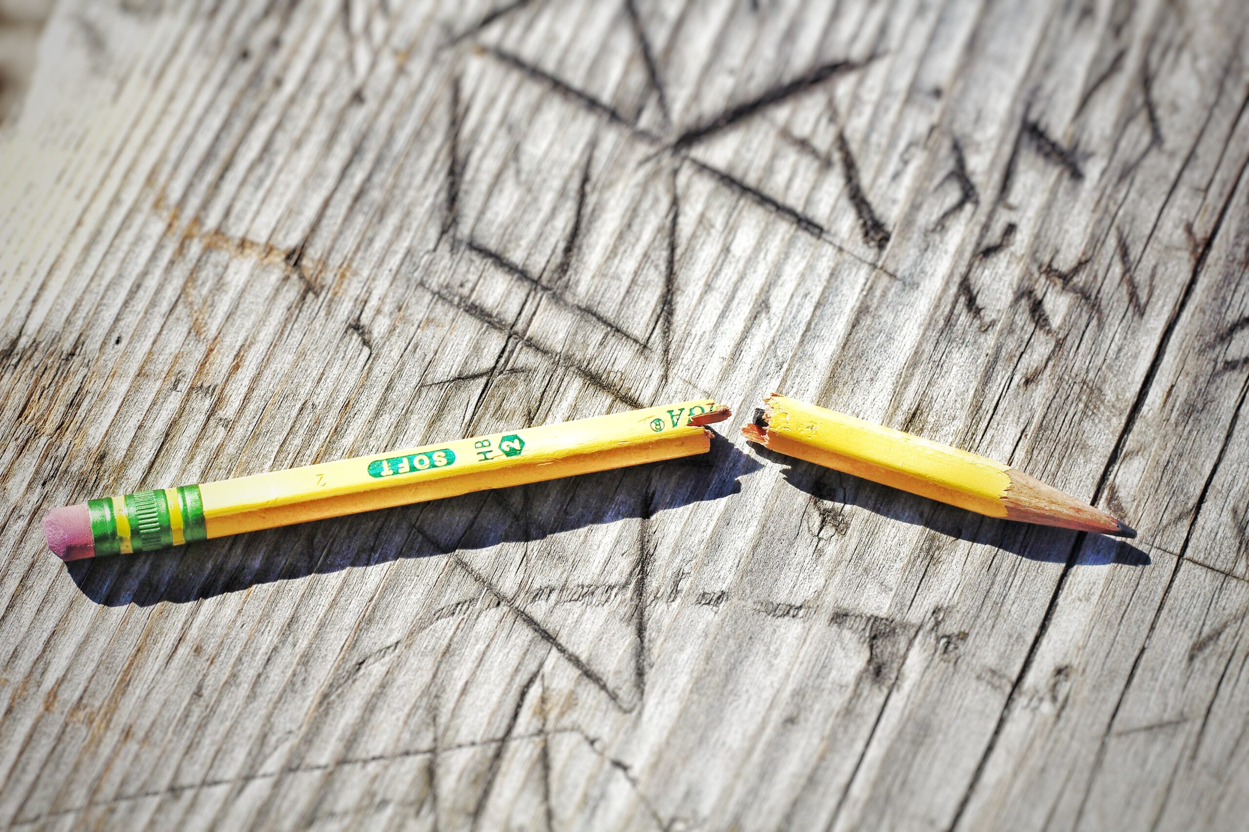 image of broken pencil on desk.