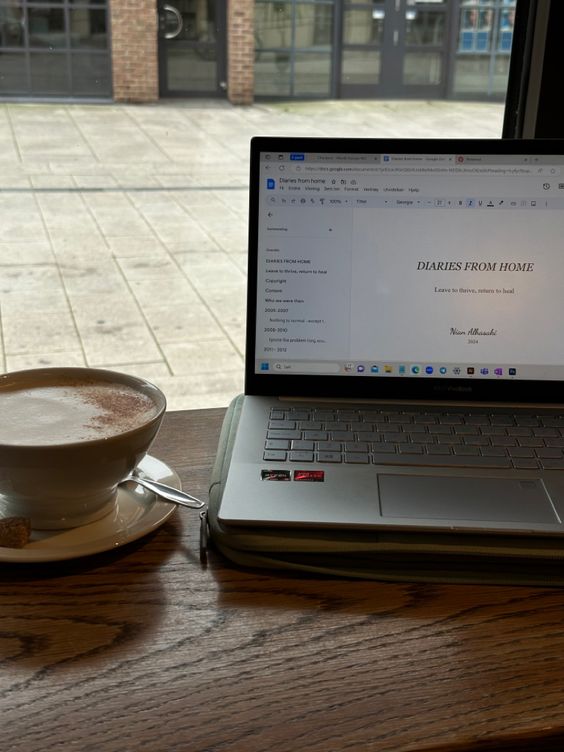 cafe setting with laptop and a cup of coffee