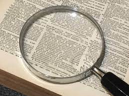 magnify glass over a book page