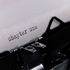 image shows a typewriter that has written "chapter one" on it's page