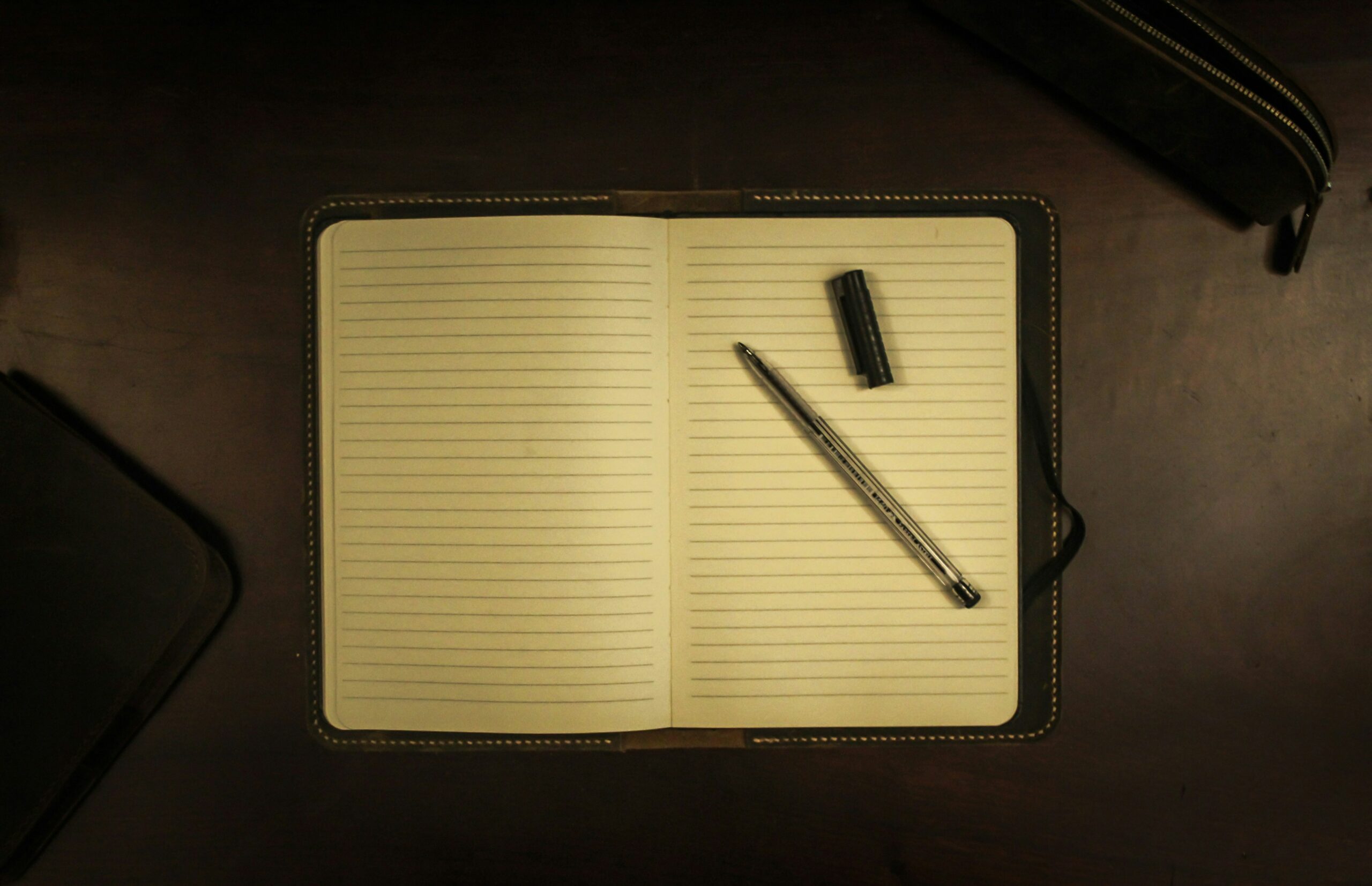 a black notebook, which could symbolize writers block or the beginning of the writing process.