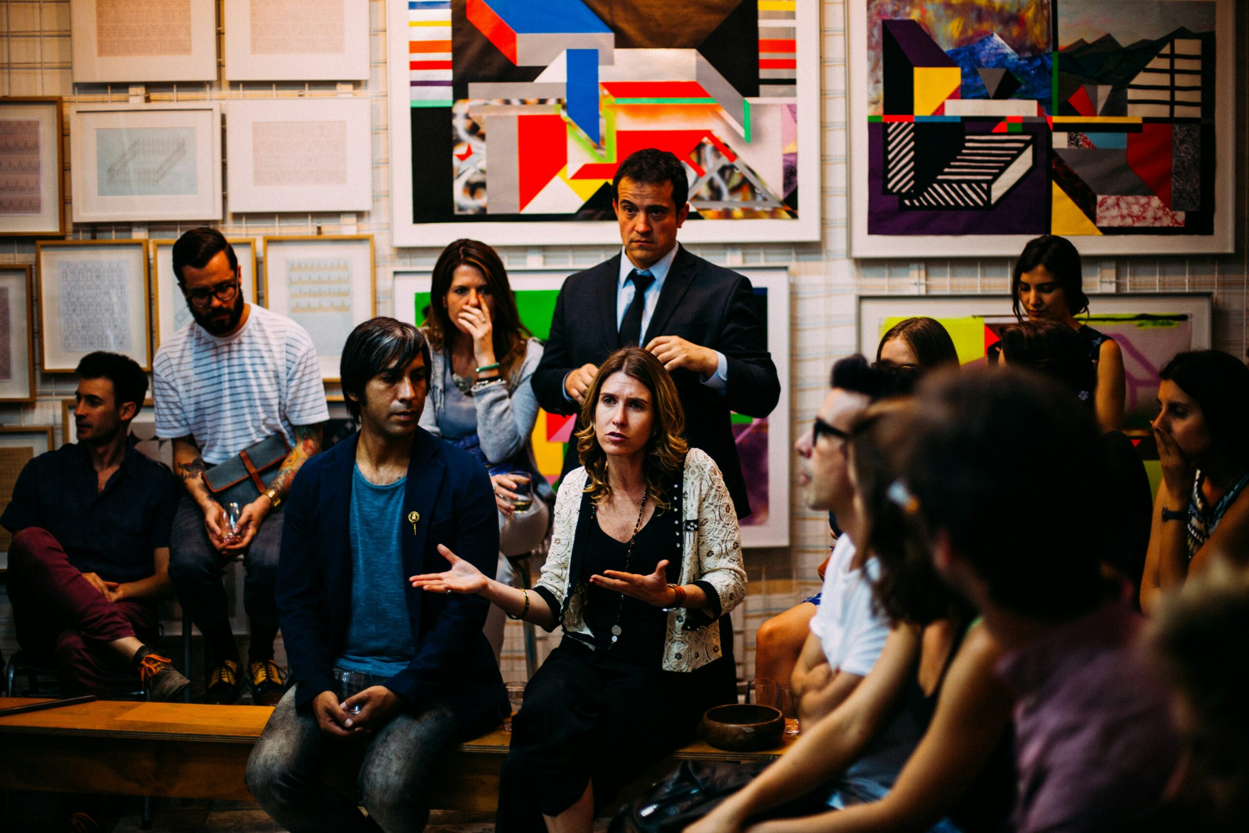 There are a group of people gathered together in a room. They appear to be having an important meeting.