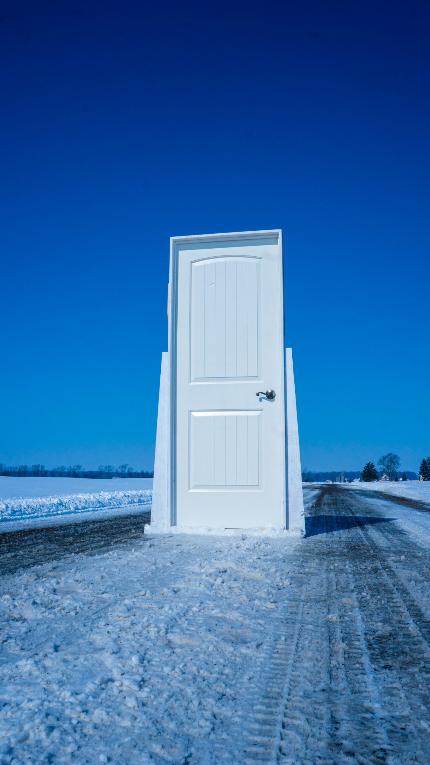 White wooden door near body of water during the daytime