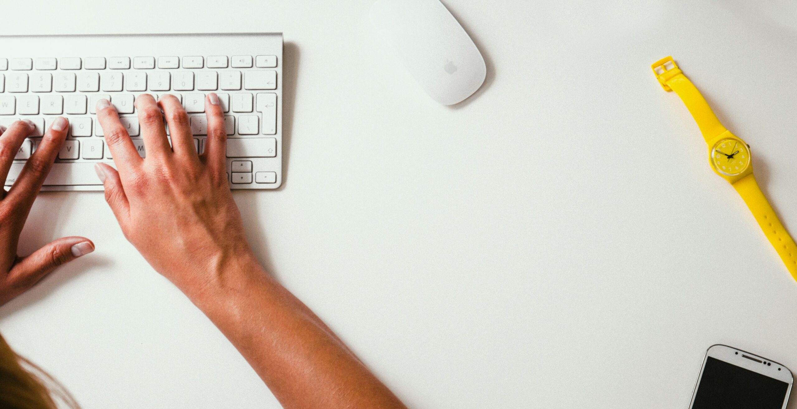 Image of a hand typing on a keyboard