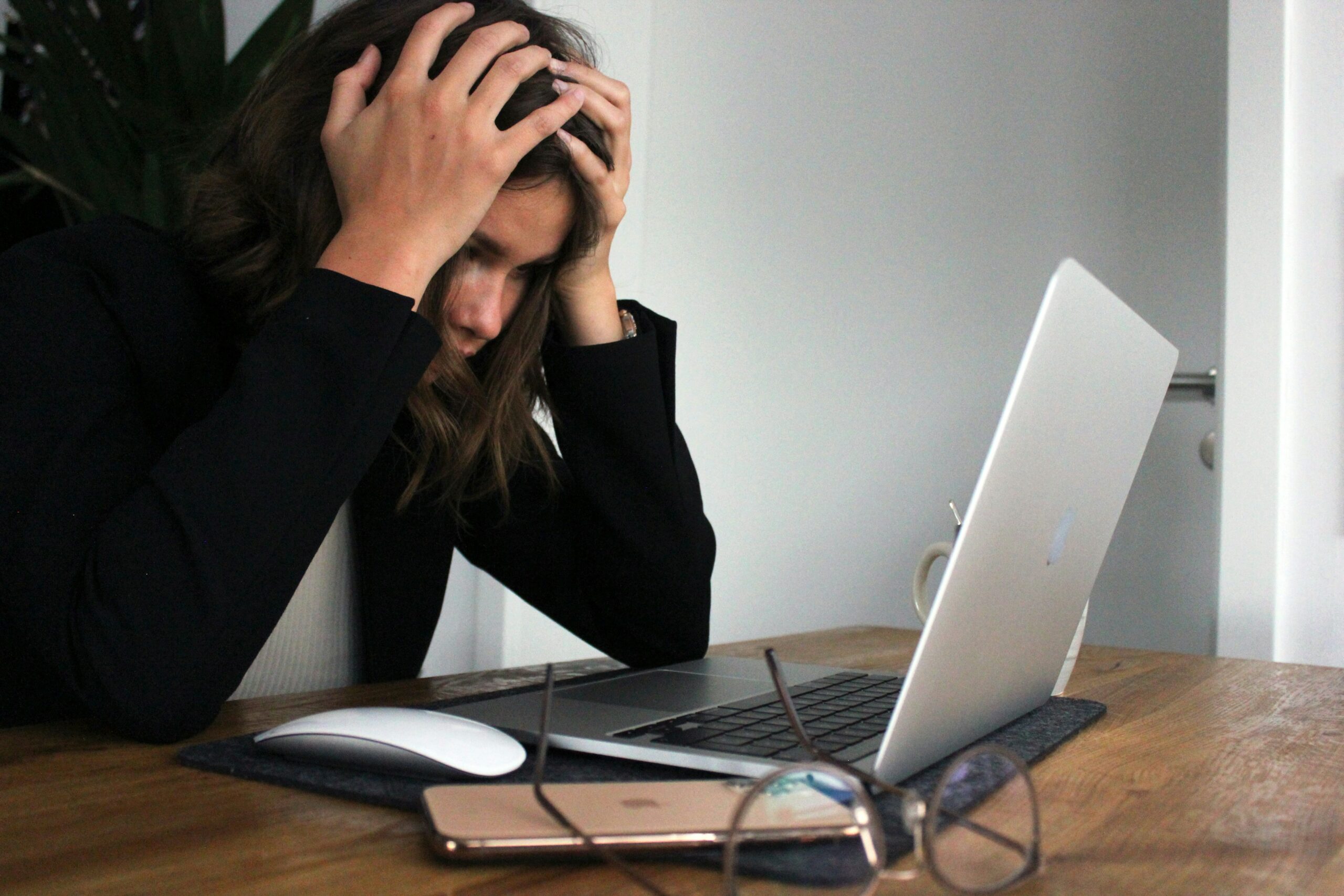 women stressed with hands on head trying to edit paper