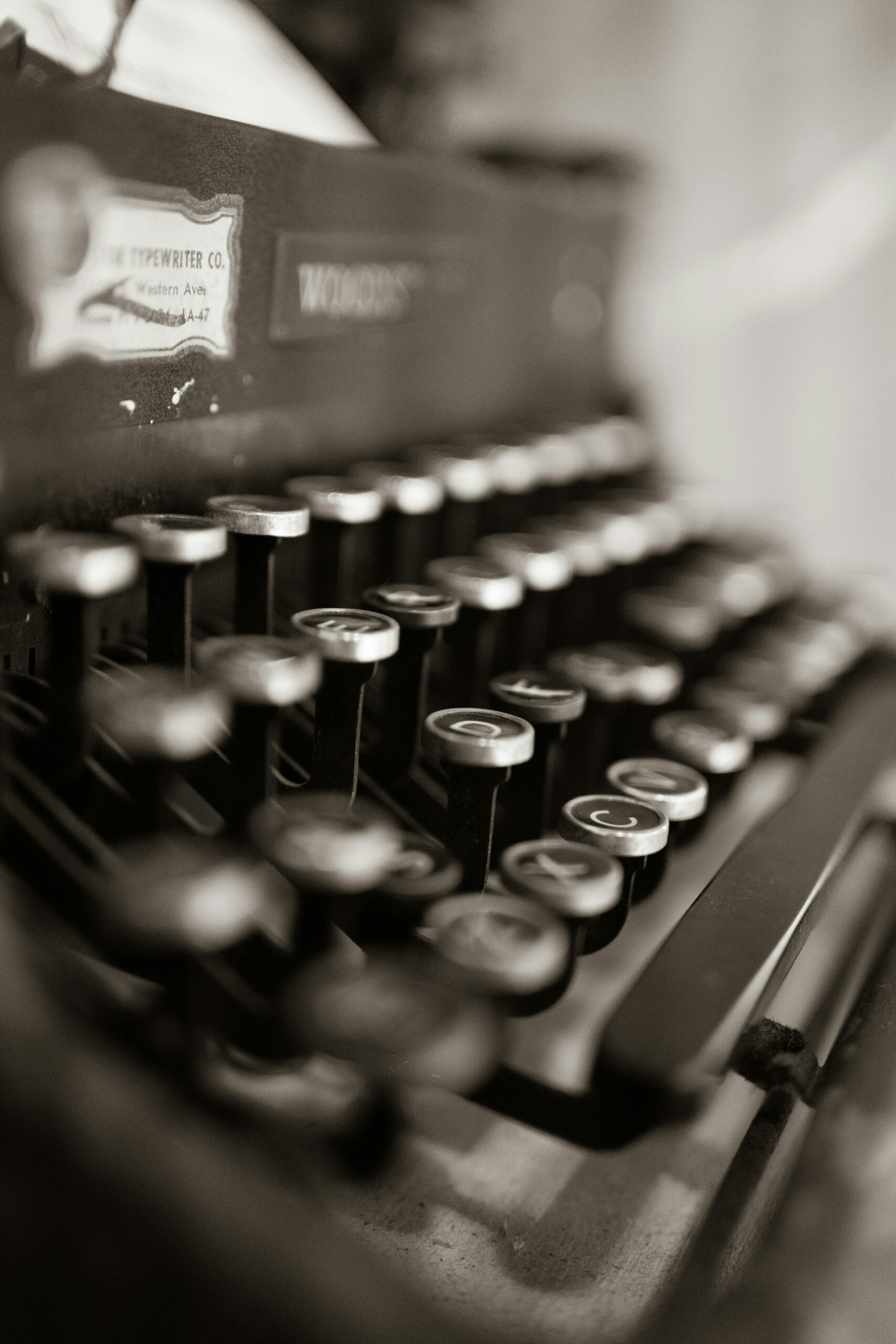 A zoomed-in photo of a typewriter and its keys.