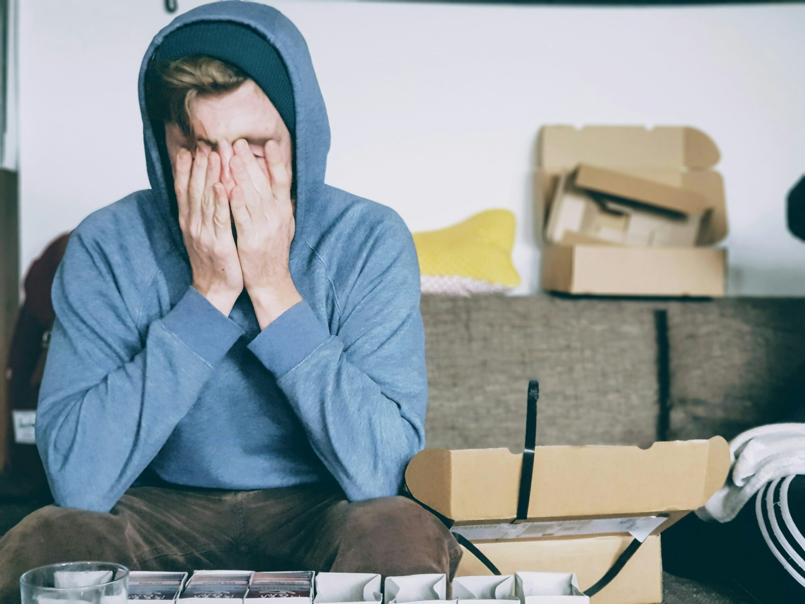 person with hands over face stressed and anxious