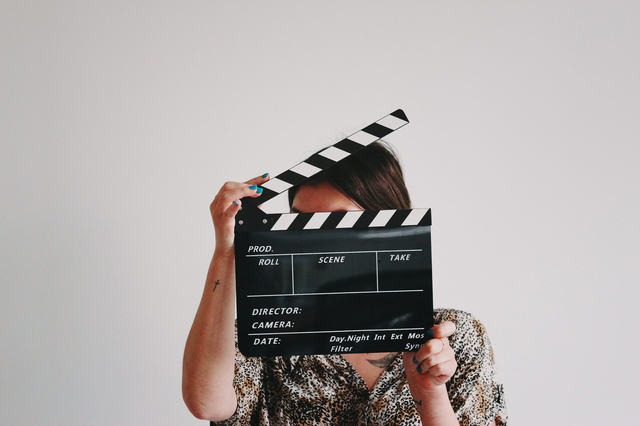 A person is holding up a clapperboard.