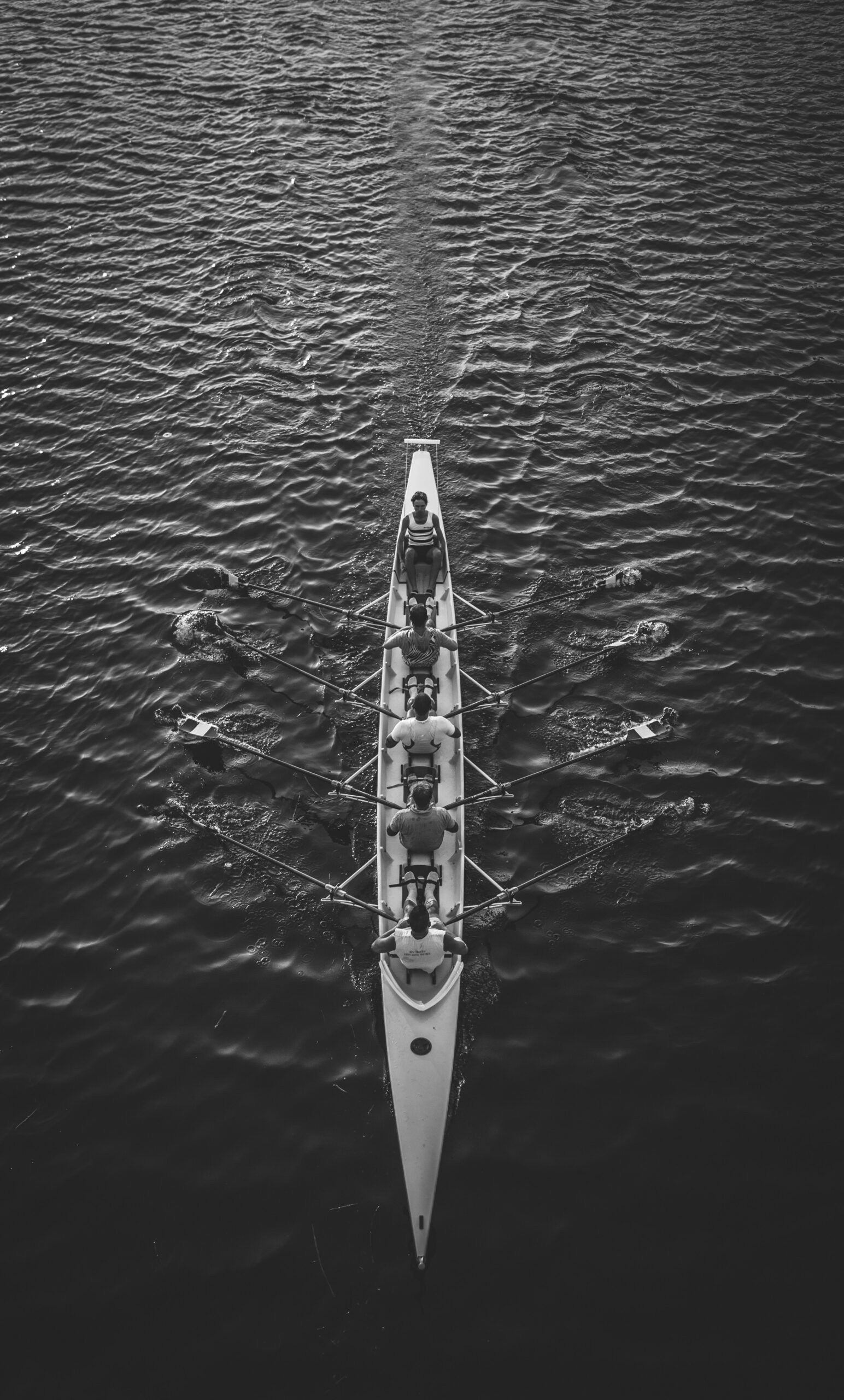 People rowing a boat on a body of water.