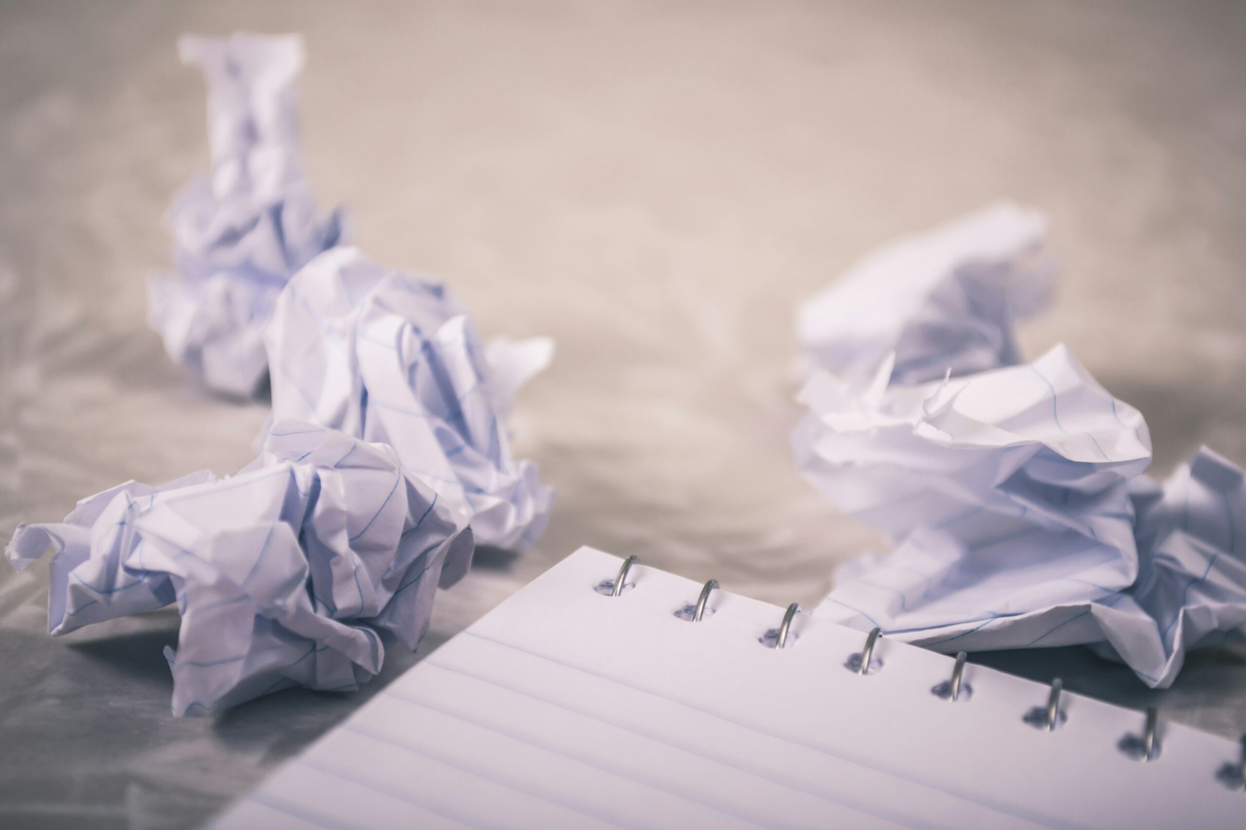 Pile of crumpled up notebook paper representing writer's block